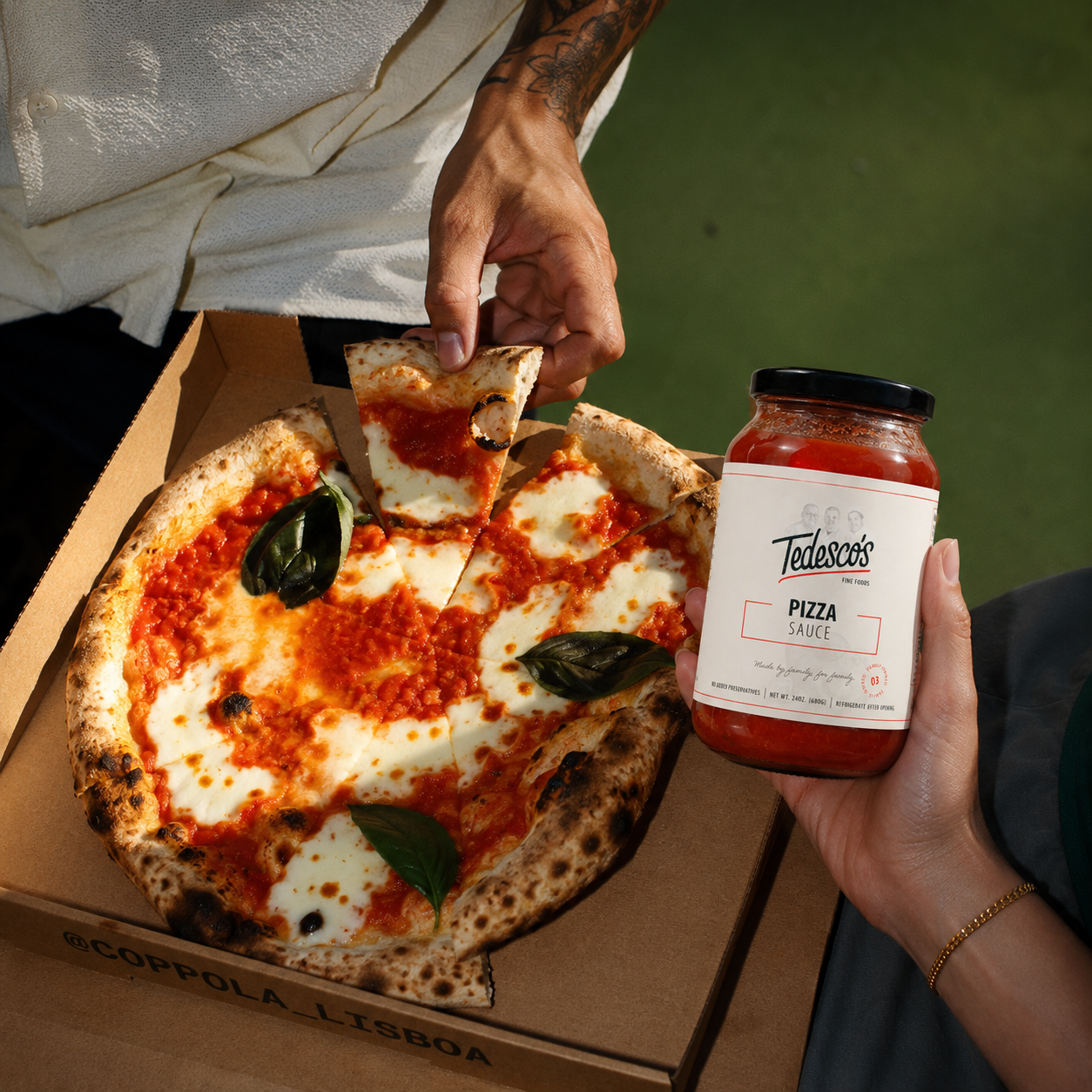 A margherita pizza served with a jar of Tedesco's Pizza Sauce
